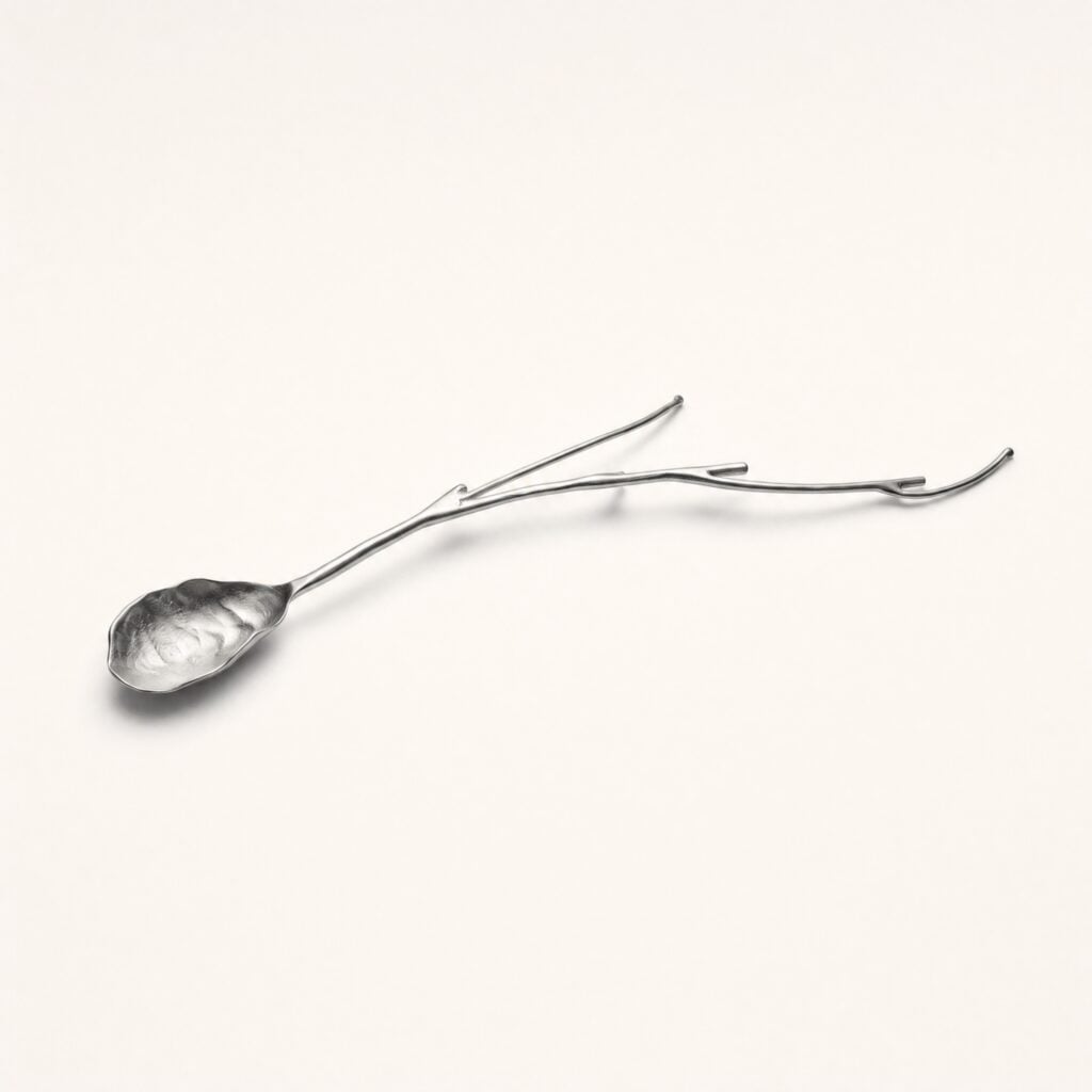 Leaf serving spoon in brushed stainless steel, cast as a branch with a veined bowl and a forked handle